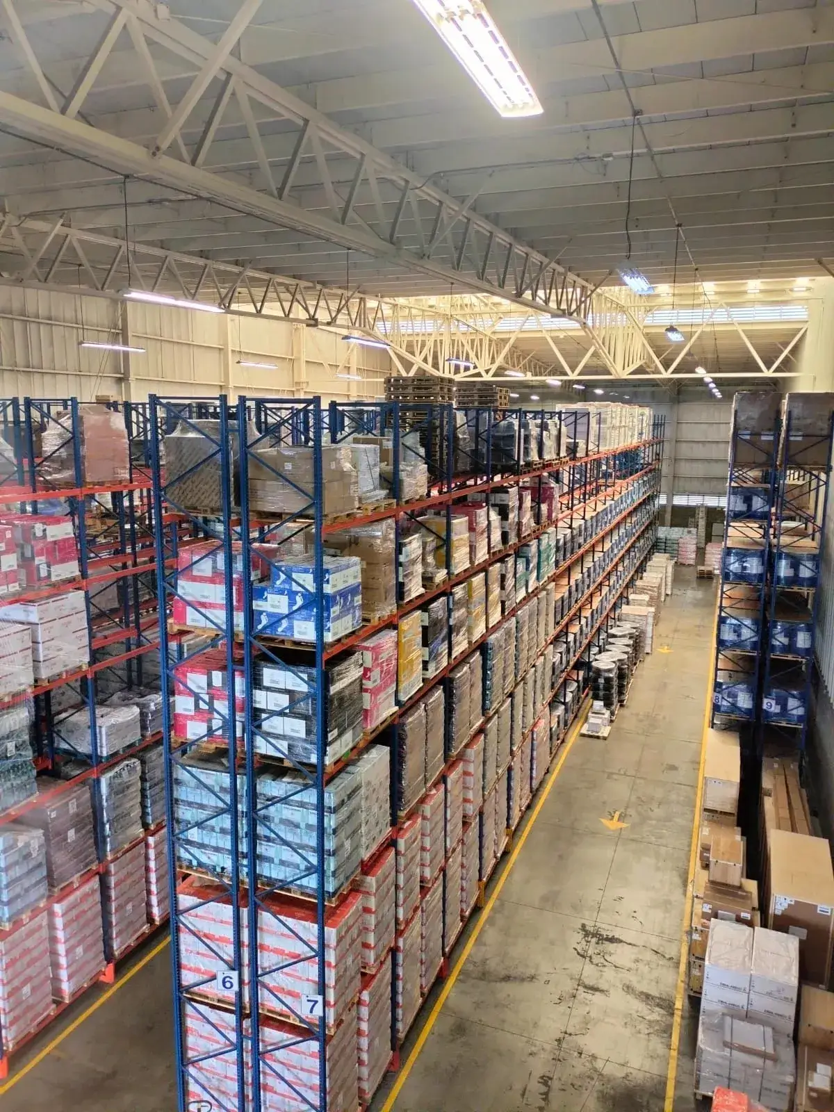 Warehouse aisle lined with tall pallet racks